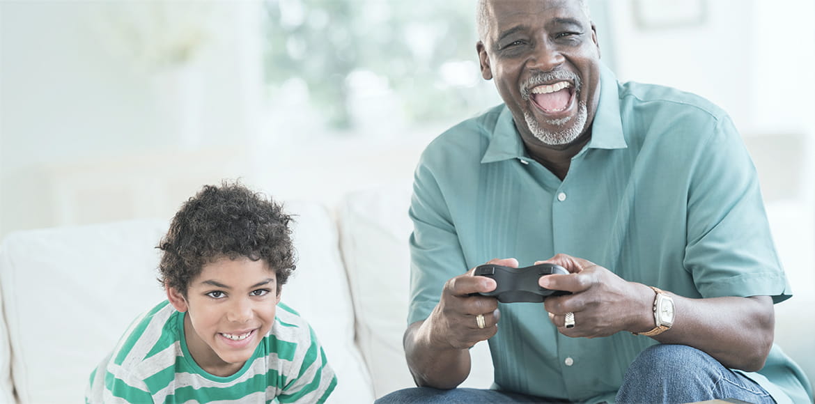 boy playing video games with grandfather